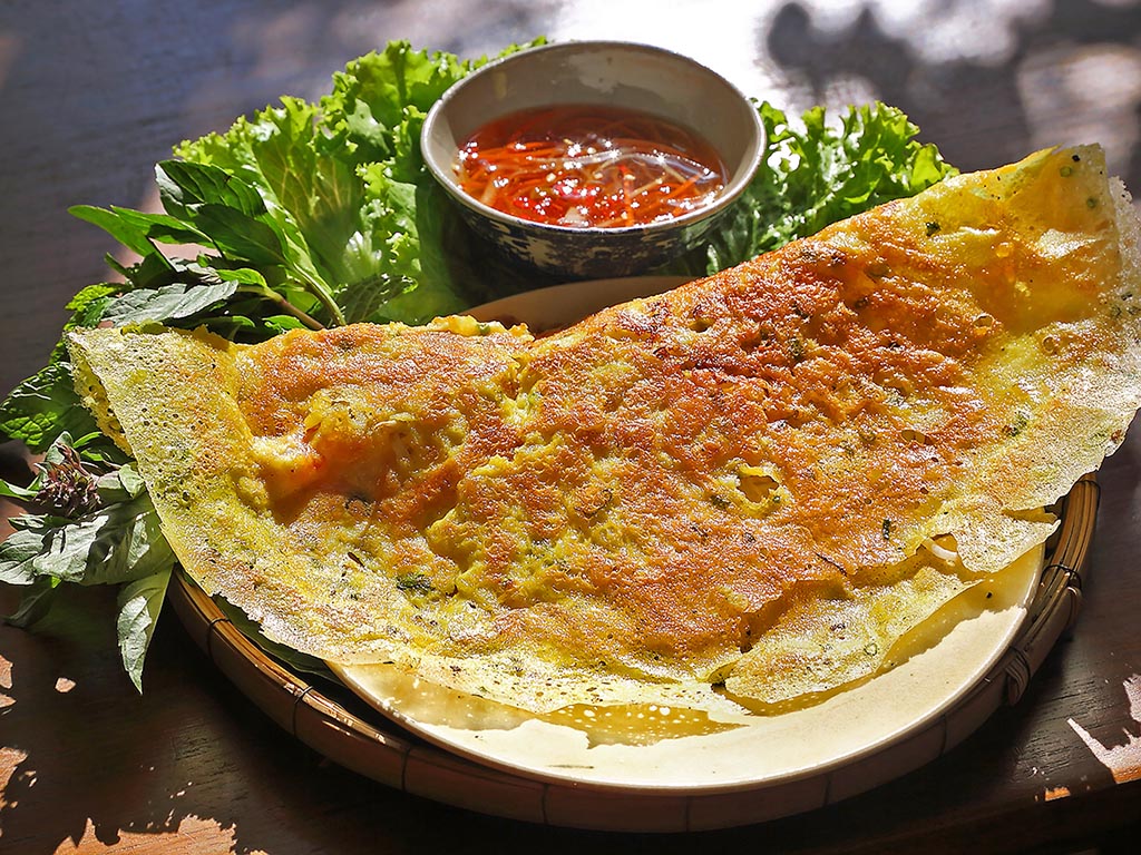 Banh Xeo is named after an onomatopoeia depicting the sound of sizzling batter poured into a hot pan.
